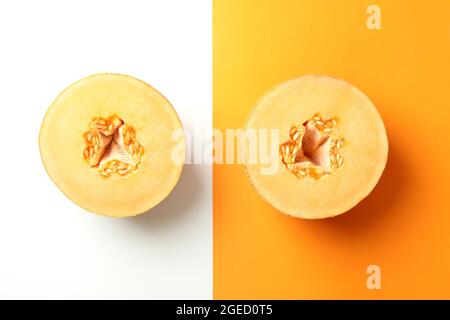 Melon halves on two tone background, top view Stock Photo