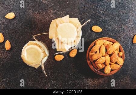 Plant based almod milk in bottles on brown background. Copy space. Top ...