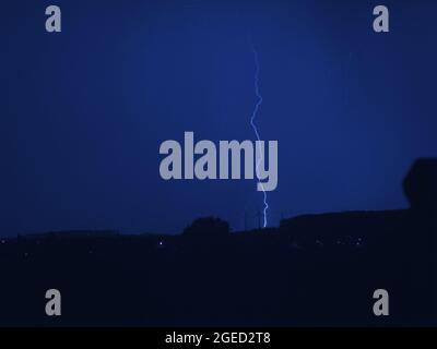 Eerie scenery of a lightning strike at night Stock Photo