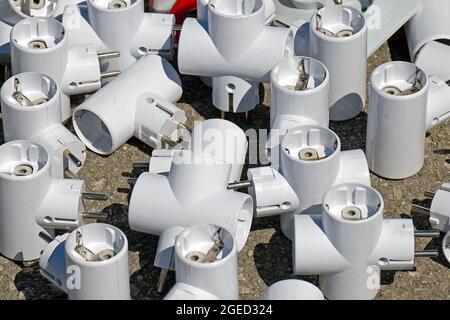 Bunch of electric plugs adapters used for electricity in most European countries mostly by tourist while traveling abroad sold on market Stock Photo