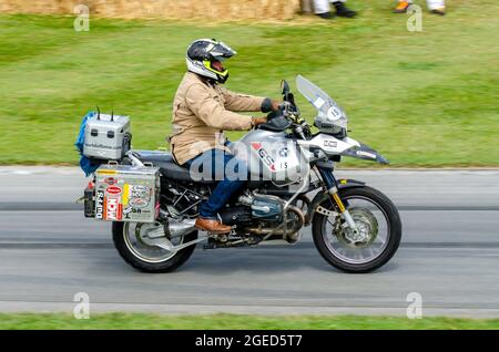 Charley Boorman riding BMW R1150GS Adventure motorcycle up the hill climb track at the Goodwood Festival of Speed motor racing event 2014. Stock Photo