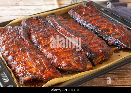 Oven roasted spare ribs on a baking sheet Stock Photo