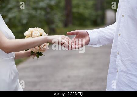 Hand to hand by wedding couple based on Michelangelo. Elegant wedding. Wedding day. Love story photography. Delicate touch by bride and groom. High qu Stock Photo