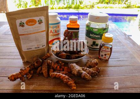 Canggu, Bali, Indonesia, April 16, 2020. Ginger and turmeric roots on the wooden table. Healthy food ingredients Stock Photo