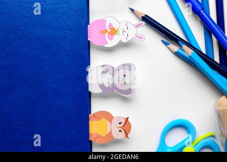 Cute bookmarks with book and stationery on white background Stock Photo