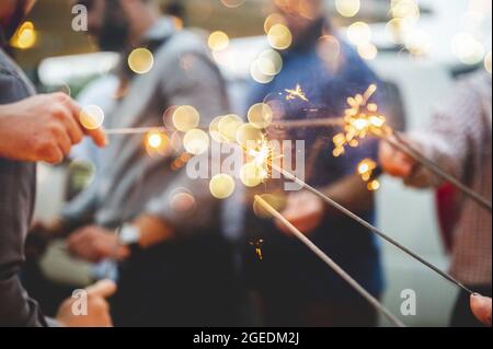 Group of people celebrating something with sparklers Stock Photo