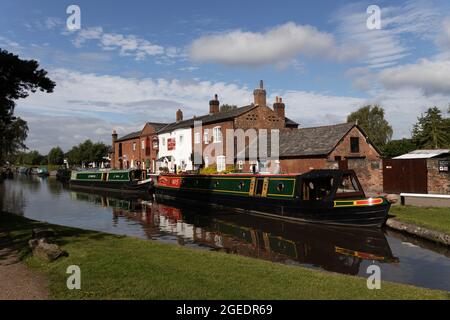 Narrow boats at Fradley Junction, where Coventry Canal meets Trent and Mersey Canal, Staffordshire, England on a bright summer's day. Stock Photo