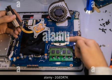 Computer repair technician repairing a laptop Stock Photo