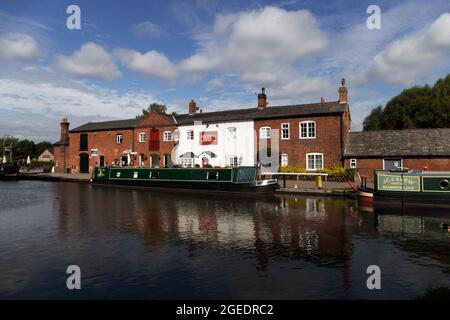 Narrow boats at Fradley Junction, where Coventry Canal meets Trent and Mersey Canal, Staffordshire, England on a bright summer's day. Stock Photo