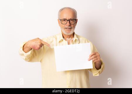 Great Offer. Cheerful Elderly Man Holding Blank Board For Text Standing Over white Studio Background. Panorama, Mockup Stock Photo