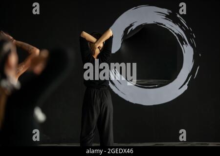 several dancers move in contact improvisation performance intentionally with motion blur ond defocus bokeh Stock Photo