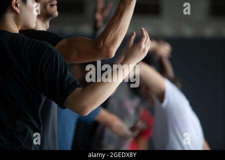 several dancers move in contact improvisation performance intentionally with motion blur ond defocus bokeh Stock Photo