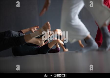several dancers move on floor n contact improvisation performance intentionally with motion blur ond defocus bokeh Stock Photo
