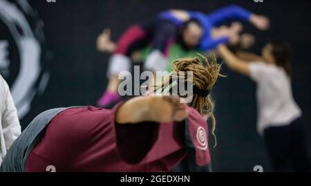 several dancers contact in contact improvisation performance intentionally with motion blur ond defocus bokeh Stock Photo