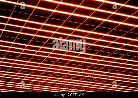 Abstraction of light-emitting diode lines, laser of a red shade of a surface on a dark background Stock Photo