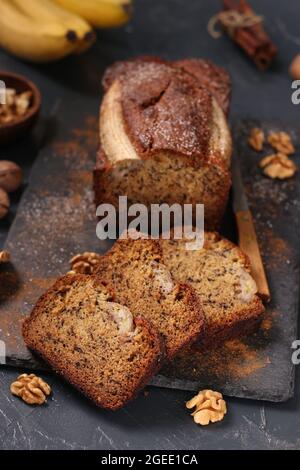 Homemade banana bread with walnut and cinnamon on a dark background Stock Photo