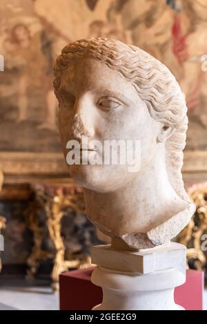 Close-up on head in ruins of ancient roman statue of woman with long hair Stock Photo