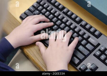 SAINT CHARLES, UNITED STATES - Apr 08, 2009: A closeup of an elementary school child's hands typing on a computer keyboard Stock Photo