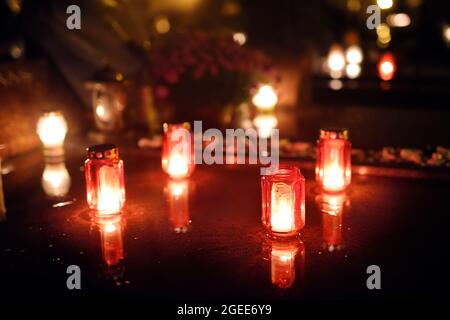 Candles lit up on All Souls Day in Lithuania. Candle flames illuminating a Lithuanian cemetery during All Saint's Day. Stock Photo