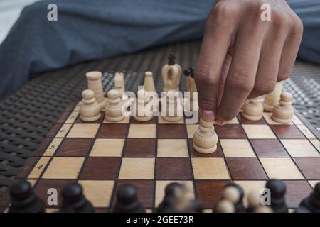 Close up of hands of a business man moving king golden chess to defeat  opponent the chess game is development analysis, strategy, and plan, the  management or leadership concept. 22804709 Stock Photo