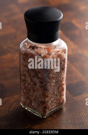 Grinder of Pink Himalayan Sea Salt on a Butcher Block Stock Photo