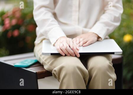 female entrepreneur hold smartphone and laptop Stock Photo
