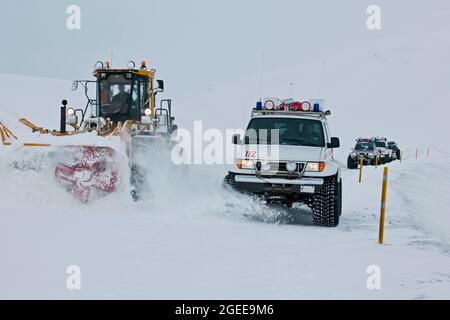 Icelandic rescueteams overtaking a snowplough after a blizzard on the mountainpass vikurskad in north Iceland Stock Photo