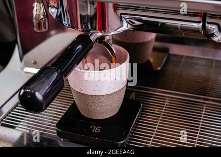 the process of making coffee in a coffee machine. male hands. Stock Photo