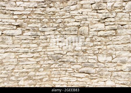 Large stone wall made by stacking small stone blocks Stock Photo