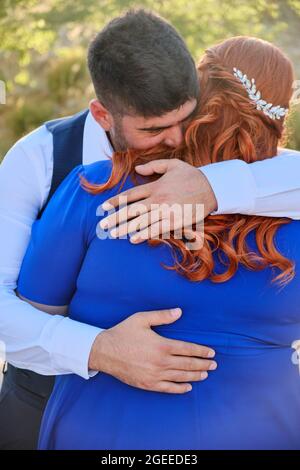 Man hugs his beloved woman smiling Stock Photo