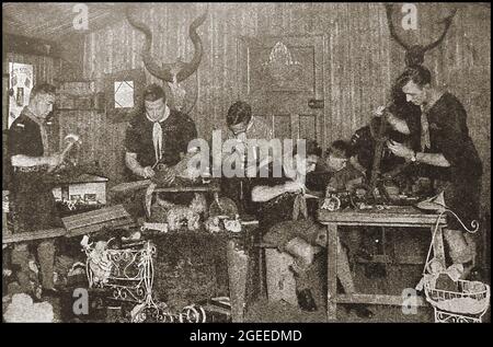 An old magazine photograph circa 1940's  showing a group of British Boy Scouts repairing collected broken toys to give to poor children. Stock Photo