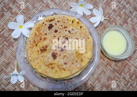 Indian special dish Bobbatlu or Bhakshalu a telugu sweets for Ugadi festival special food. Sweet chapati flat bread jaggery and lentils served with pu Stock Photo