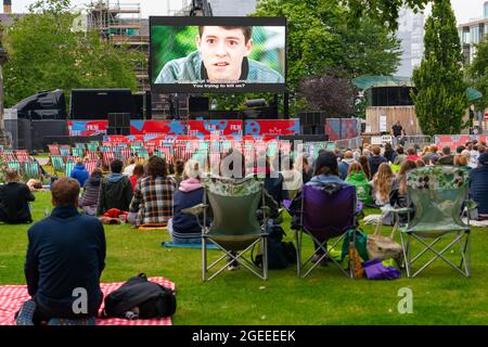 Edinburgh, Scotland, UK. 19th August  2021. Audience watch an outdoor screening of the cult movie Ferris Bueller’s Day Off at the  Film Fest in the City outdoor cinema in St Andrew Square. This is one of the events taking place during the Edinburgh International Film Festival in the city.  Iain Masterton/Alamy Live news. Stock Photo