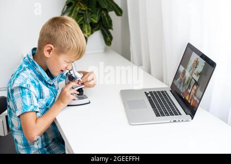 Smart Young Boy Works on a Laptop For His New Project in His Computer Science Class. Stock Photo