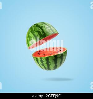 Sliced watermelon on a pastel blue background. Minimal fruit concept. Stock Photo