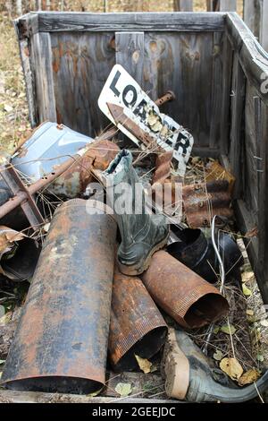 Vertical closeup of a pile of rusty metal and rubber boots Stock Photo