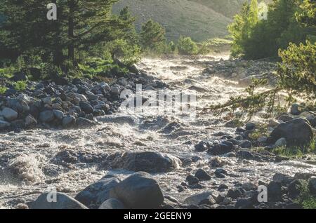 Beautiful landscape of a mountain river. A rapid flow of water from the glacier. Rafting in the mountains. Stock Photo