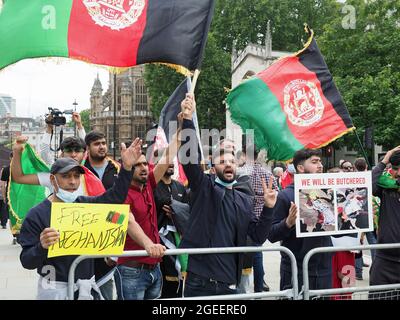A group of Afghans and former Afghan interpreters protesting outside the UK Westminster Parliament in London on 18 August 2021