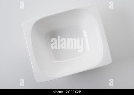 New deep rectangular-shaped white porcelain plate on white background Stock Photo