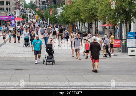 Montreal, CA - 17 July 2021: People walking on Sainte Catherine Street at the Place des Arts. Stock Photo