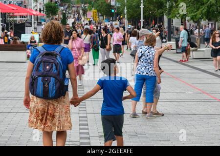 Montreal, CA - 17 July 2021: People walking on Sainte Catherine Street at the Place des Arts. Stock Photo