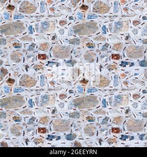 Seamless texture of wall made of multicolored stones. Asymmetric masonry. Four fragments in one. Stock Photo