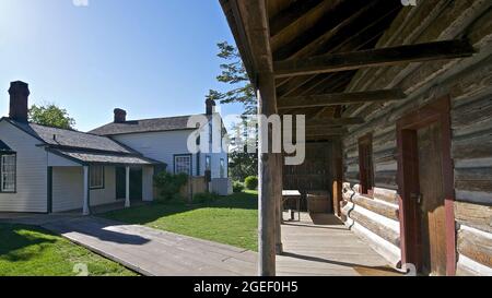 Wooden log cabin front porch and the building exterior of a historic house Stock Photo