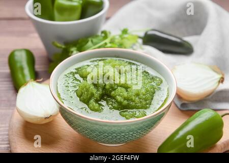 Bowl of Tomatillo Salsa Verde sauce on table Stock Photo