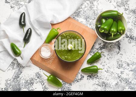 Blender with Tomatillo Salsa Verde sauce and jalapeno pepper on grunge background Stock Photo