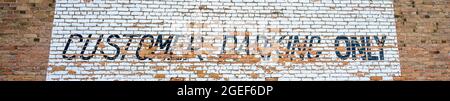 Grungy customer paring only sign painted on a rustic brick wall Stock Photo