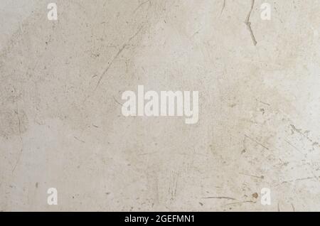 A light gray plastered wall. Scratched old wall in close-up. Abstract background. Architecture Stock Photo