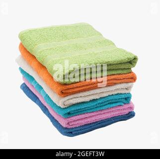 Stacked multicolored towels on white background Stock Photo