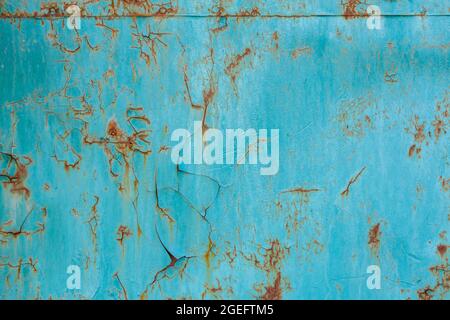 turquoise painted flat steel sheet with cracks and rust stains Stock Photo