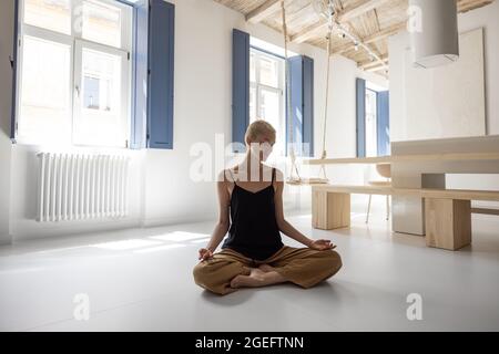 Woman meditating at home Stock Photo